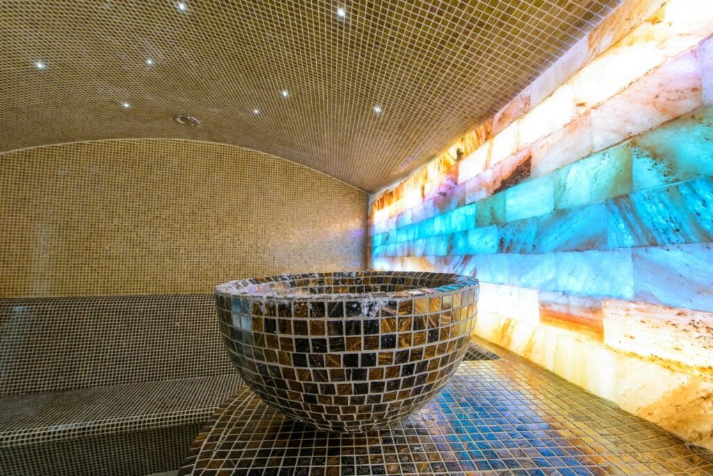 a big bowl made of tile pices in a large steam room