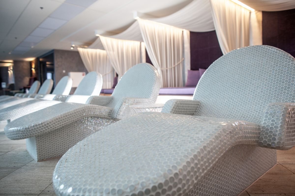 Large white steam room seating arrangements made of tiles