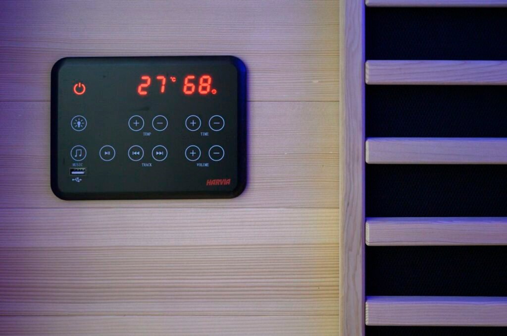 control panel with buttons and temperature display on a wall