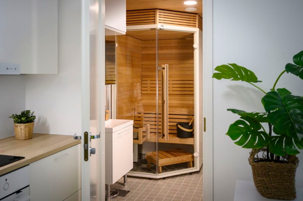 wood lined sauna cabin in a bathroom view from kitchen